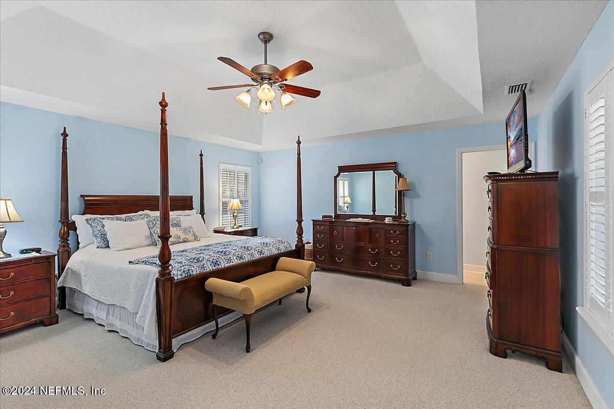 9058 Butcher Road Glen St. Mary, FL 32040 - Photo 19 of 43 a bedroom with a bed and a chandelier