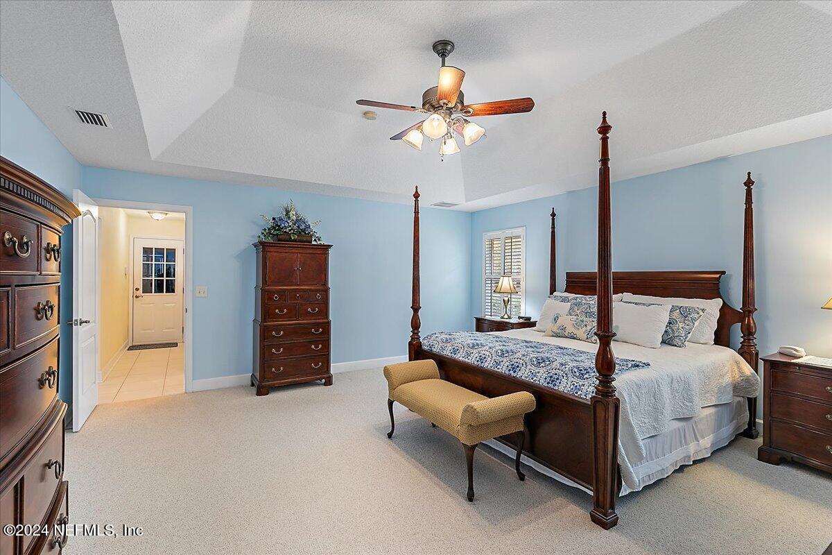9058 Butcher Road Glen St. Mary, FL 32040 - Photo 20 of 43 a bedroom with a bed and a chandelier