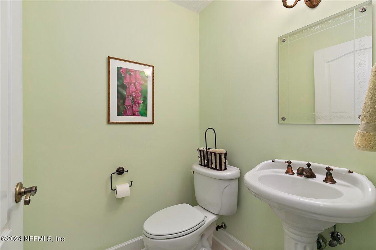 9058 Butcher Road Glen St. Mary, FL 32040 - Photo 24 of 43 a bathroom with a sink mirror and toilet