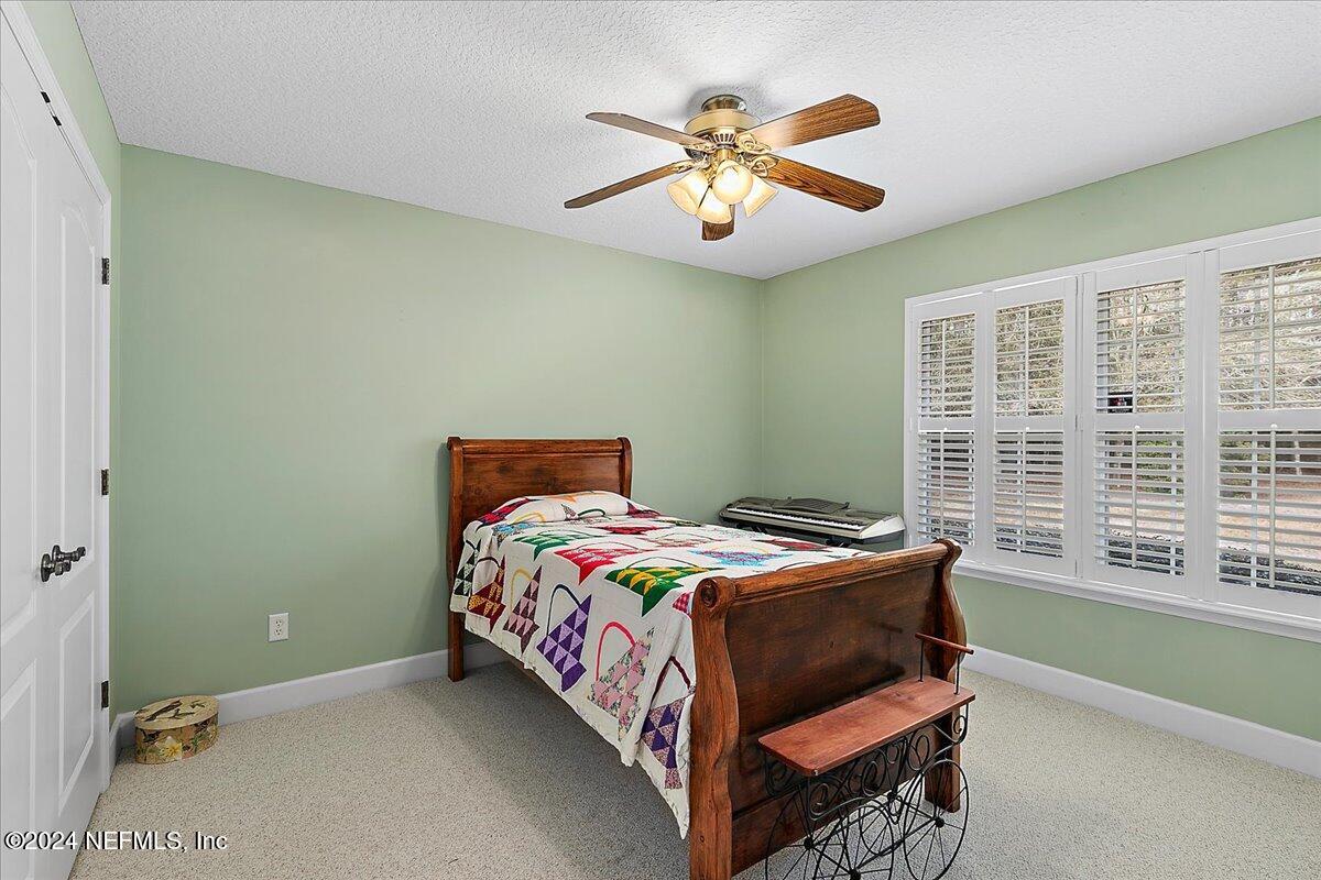 9058 Butcher Road Glen St. Mary, FL 32040 - Photo 26 of 43 a bedroom with a bed and a window