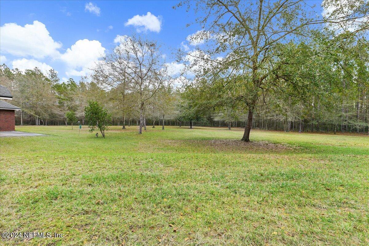 9058 Butcher Road Glen St. Mary, FL 32040 - Photo 31 of 43 a view of outdoor space with deck and yard