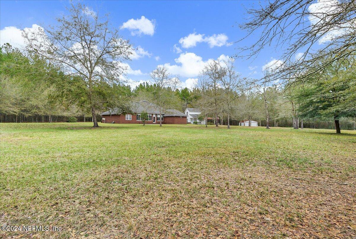 9058 Butcher Road Glen St. Mary, FL 32040 - Photo 32 of 43 a view of yard with tree s