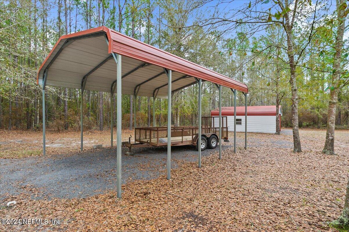 9058 Butcher Road Glen St. Mary, FL 32040 - Photo 38 of 43 a backyard of a house with a swing table and chairs