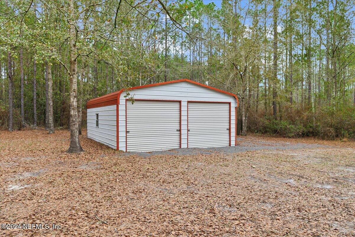 9058 Butcher Road Glen St. Mary, FL 32040 - Photo 39 of 43 a house with trees in the background