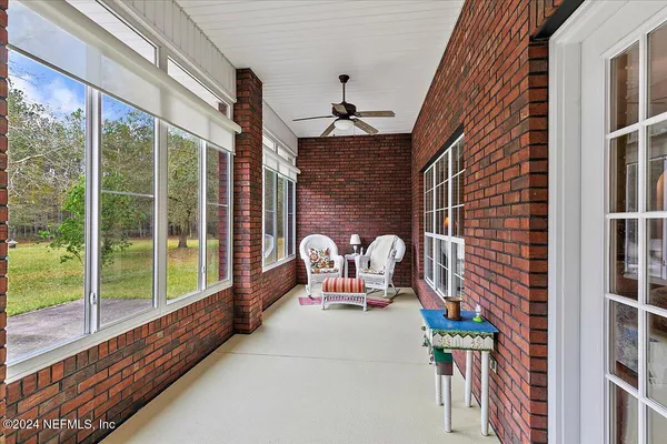 a view of a porch with a table and chairs