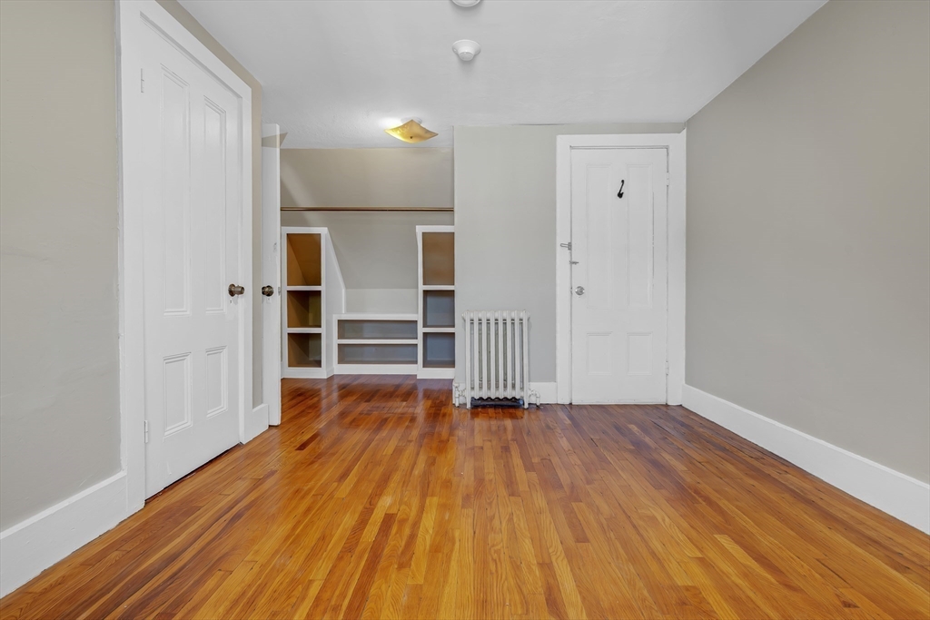 28 Evergreen Street, Unit 3 Boston, MA 02130 - Photo 10 of 16 wooden floor in an empty room with a window