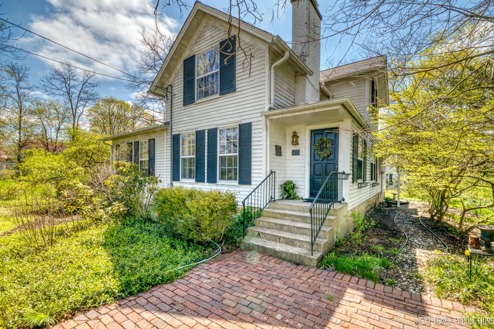 32W115 Army Trail Road Wayne, IL 60184 - Photo 1 of 1 a view of a white house with a large windows and flower plants