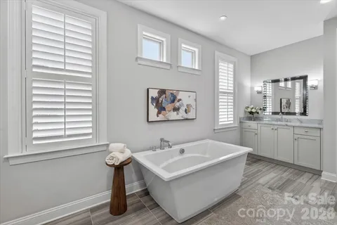 a bathroom with a sink a toilet a shower and a mirror