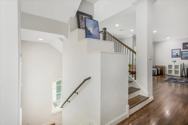 a view of entryway and hall with wooden floor