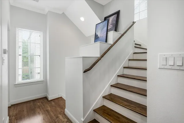 a view of entryway and hall with wooden floor