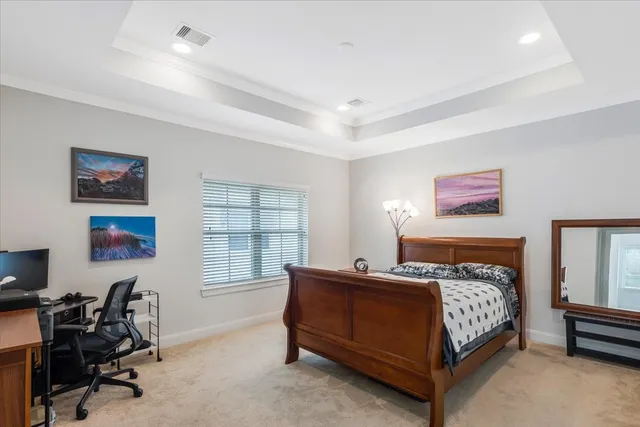 a bedroom with a bed a table and chair