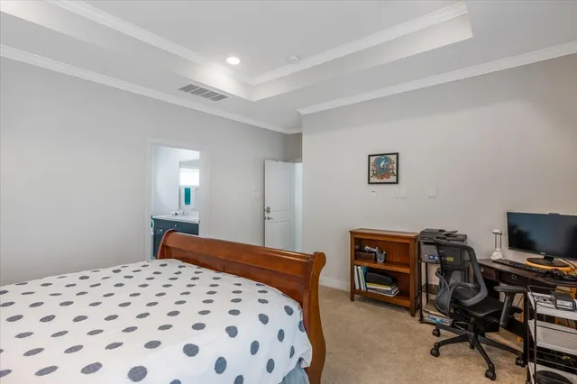 a bedroom with a bed and a television