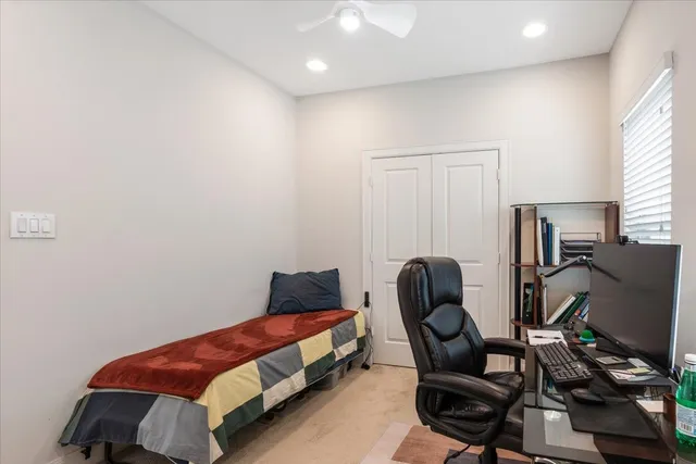 a bedroom with a bed and chair