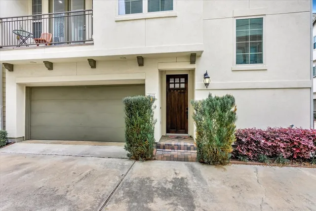 a front view of a house with plants