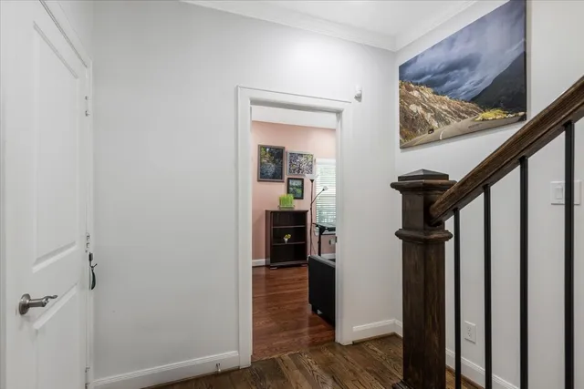 a view of a hallway view with wooden floor and staircase