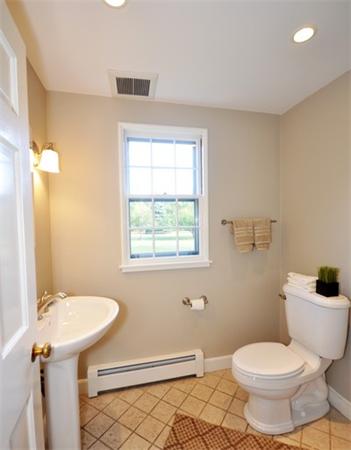 292 Musketaquid Road Concord, MA 01742 - Photo 15 of 28 a white toilet sitting next to a bathroom sink