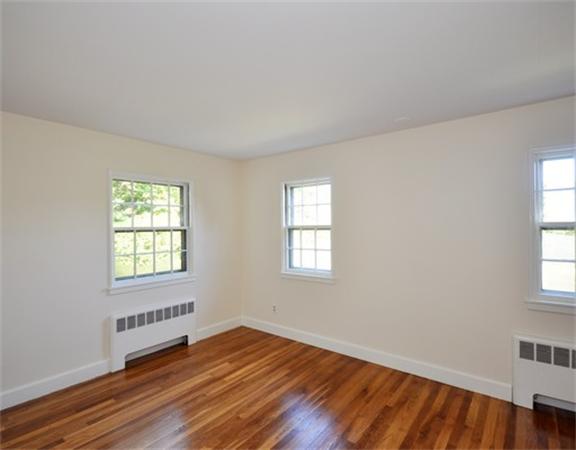 292 Musketaquid Road Concord, MA 01742 - Photo 16 of 28 a view of an empty room with wooden floor and a window