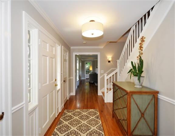292 Musketaquid Road Concord, MA 01742 - Photo 2 of 28 a view of a hallway to a livingroom with furniture and wooden floor