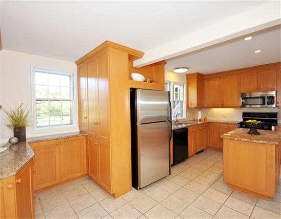 292 Musketaquid Road Concord, MA 01742 - Photo 7 of 28 a kitchen with a refrigerator a stove top oven a sink and dishwasher