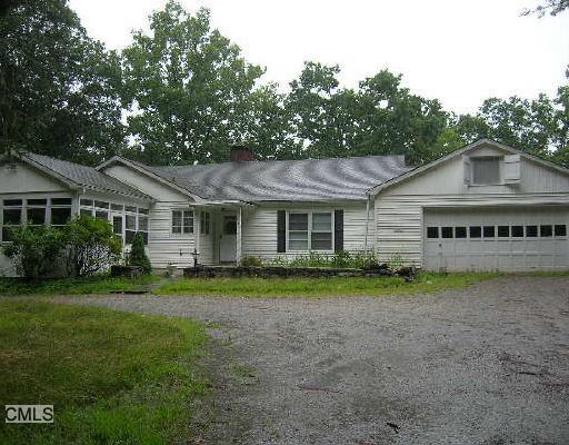 38 Laurel Hill Road Ridgefield, CT 06877 - Photo 1 of 1 a front view of a house with a garden
