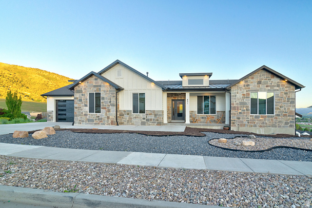 851 Grandview Drive Morgan, UT 84050 - Photo 62 of 68 Modern ranch-style home featuring a stone and board-and-batten facade, a dark gray roof, and a contemporary garage door