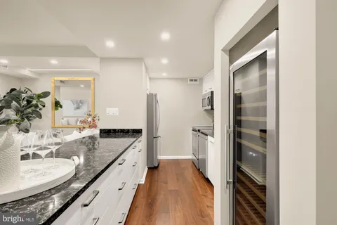 a kitchen with granite countertop a sink and a stove top oven
