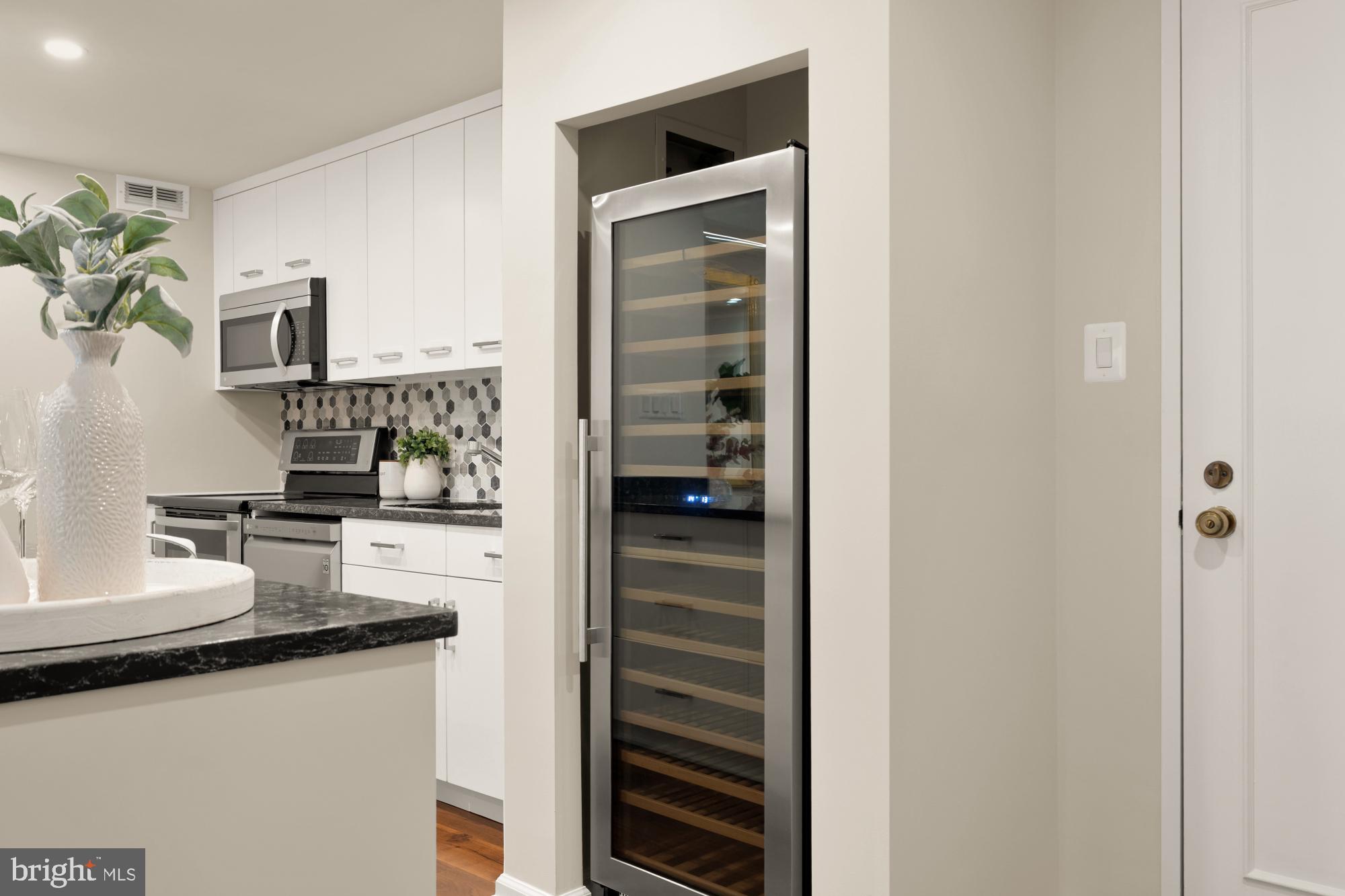 2555 Pennsylvania Avenue Northwest, Unit 617 & 618 Washington, DC 20037 - Photo 12 of 56 a kitchen with granite countertop a sink and a stove top oven