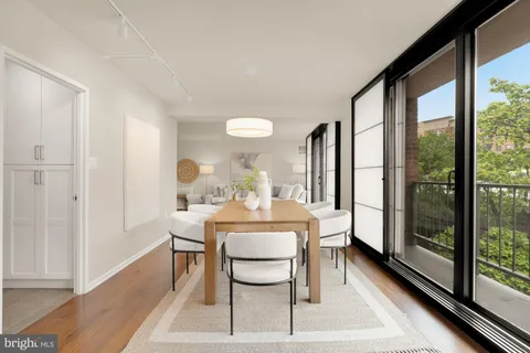 a living room with furniture a table and a potted plant