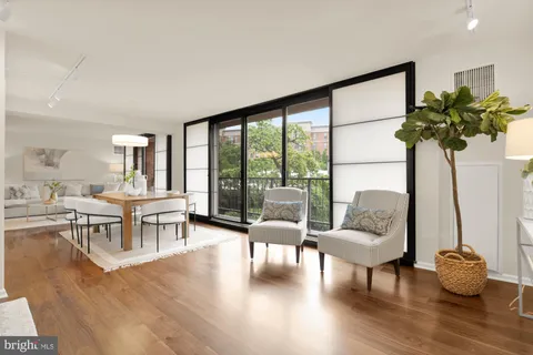 a living room with furniture and a mirror