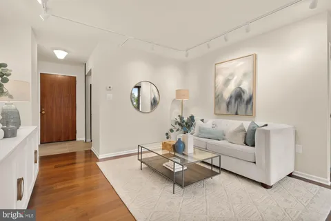 a view of kitchen with kitchen island wooden floor and living room
