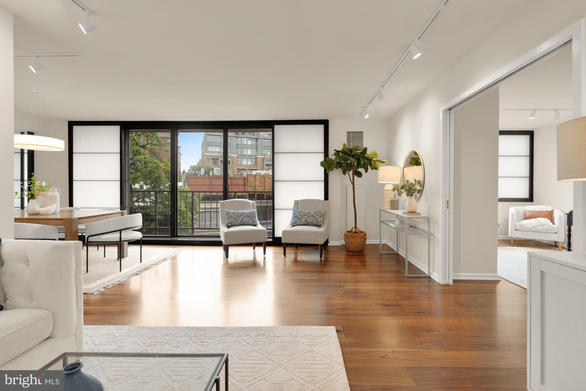 2555 Pennsylvania Avenue Northwest, Unit 617 & 618 Washington, DC 20037 - Photo 23 of 56 a living room with furniture and large windows with wooden floor
