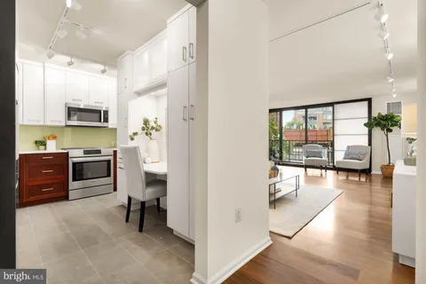 a kitchen with stainless steel appliances a refrigerator sink and cabinets