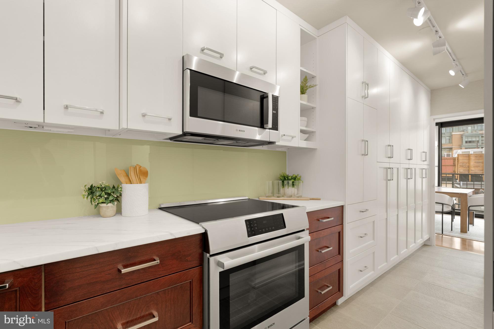 2555 Pennsylvania Avenue Northwest, Unit 617 & 618 Washington, DC 20037 - Photo 25 of 56 a kitchen with stainless steel appliances white cabinets and a stove