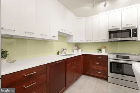 a bedroom with bed and large windows