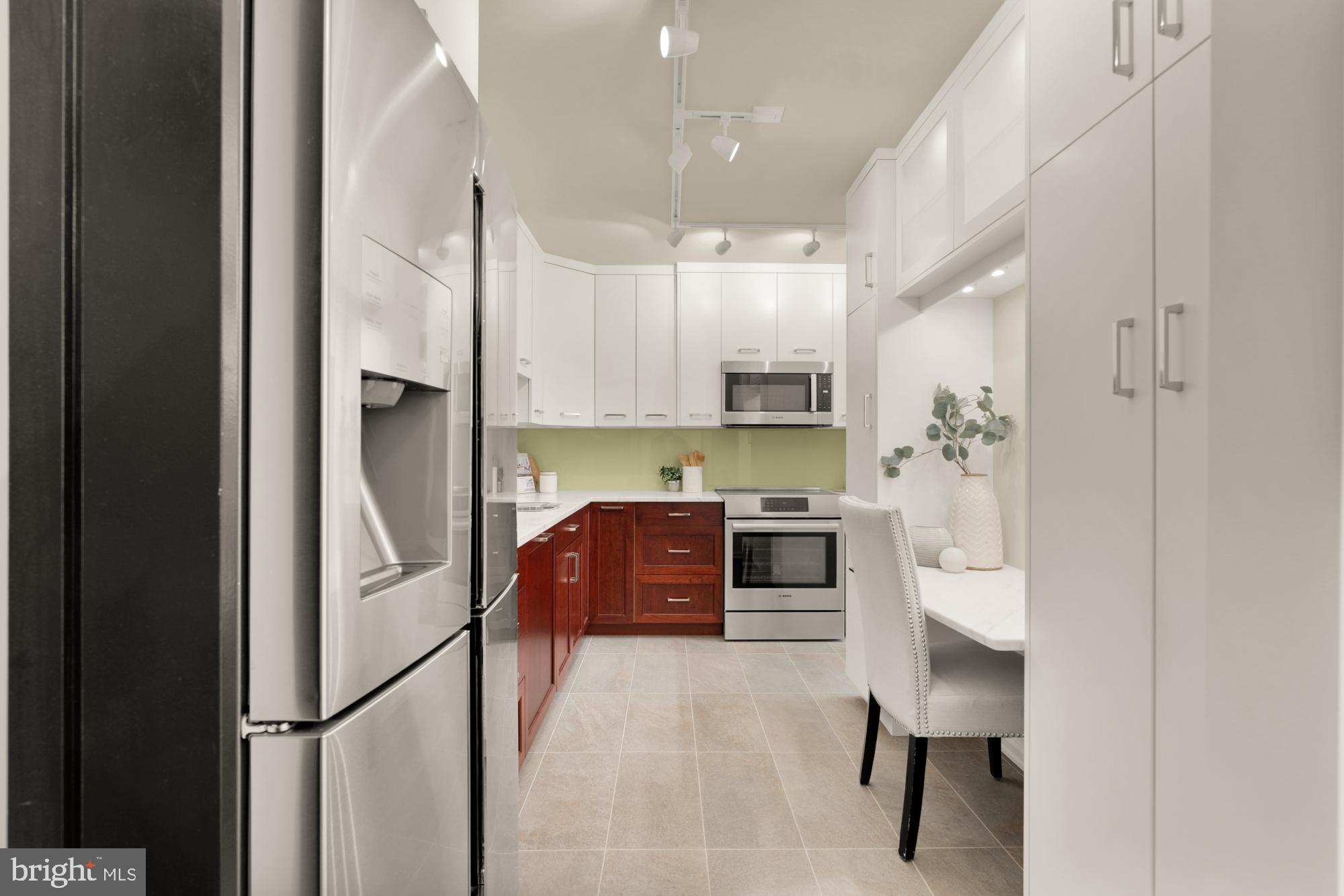 2555 Pennsylvania Avenue Northwest, Unit 617 & 618 Washington, DC 20037 - Photo 27 of 56 a kitchen with stainless steel appliances a refrigerator sink and cabinets