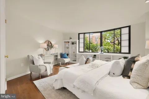 a bathroom with a granite countertop sink a toilet a mirror and shower