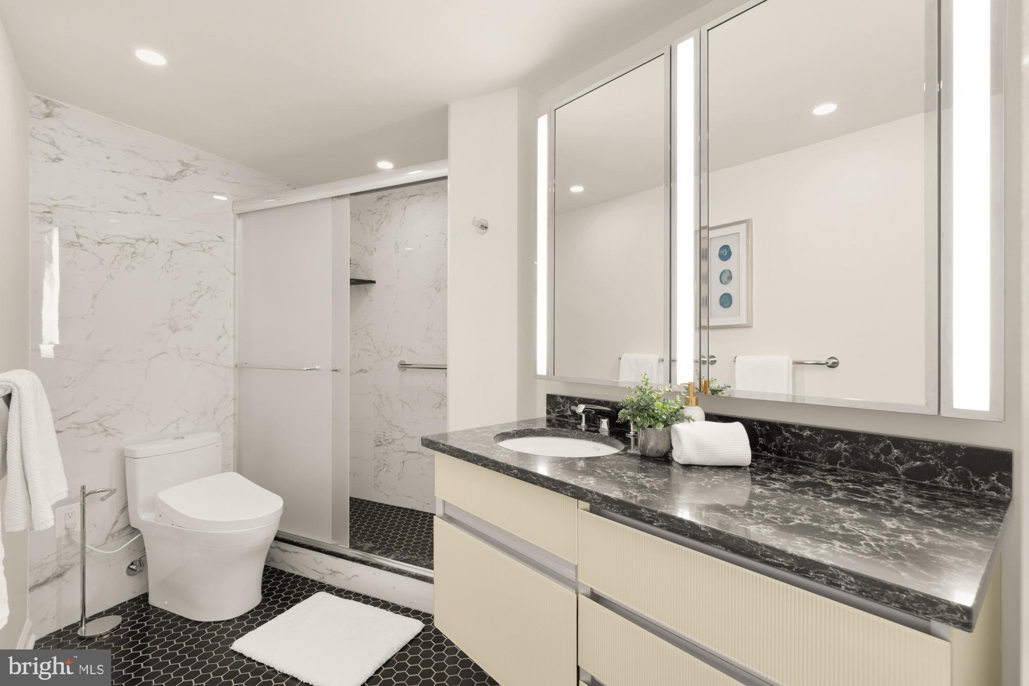 2555 Pennsylvania Avenue Northwest, Unit 617 & 618 Washington, DC 20037 - Photo 32 of 56 a bathroom with a granite countertop sink a toilet a mirror and shower