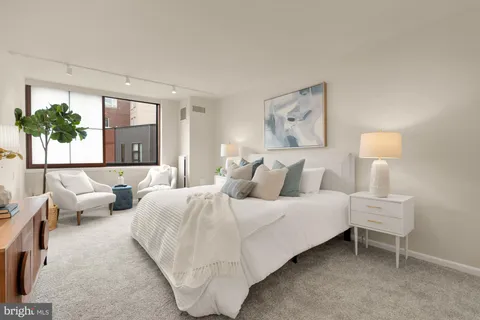 a en suite bathroom with a granite countertop sink and a mirror