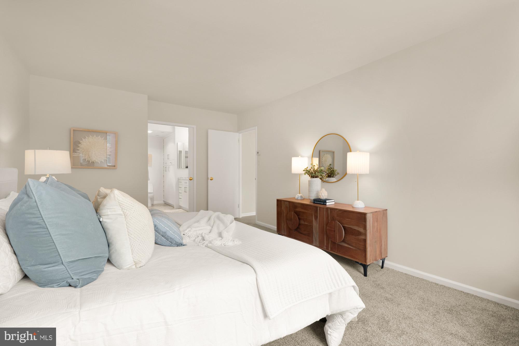 2555 Pennsylvania Avenue Northwest, Unit 617 & 618 Washington, DC 20037 - Photo 37 of 56 a bedroom with a bed large mirror and cabinet