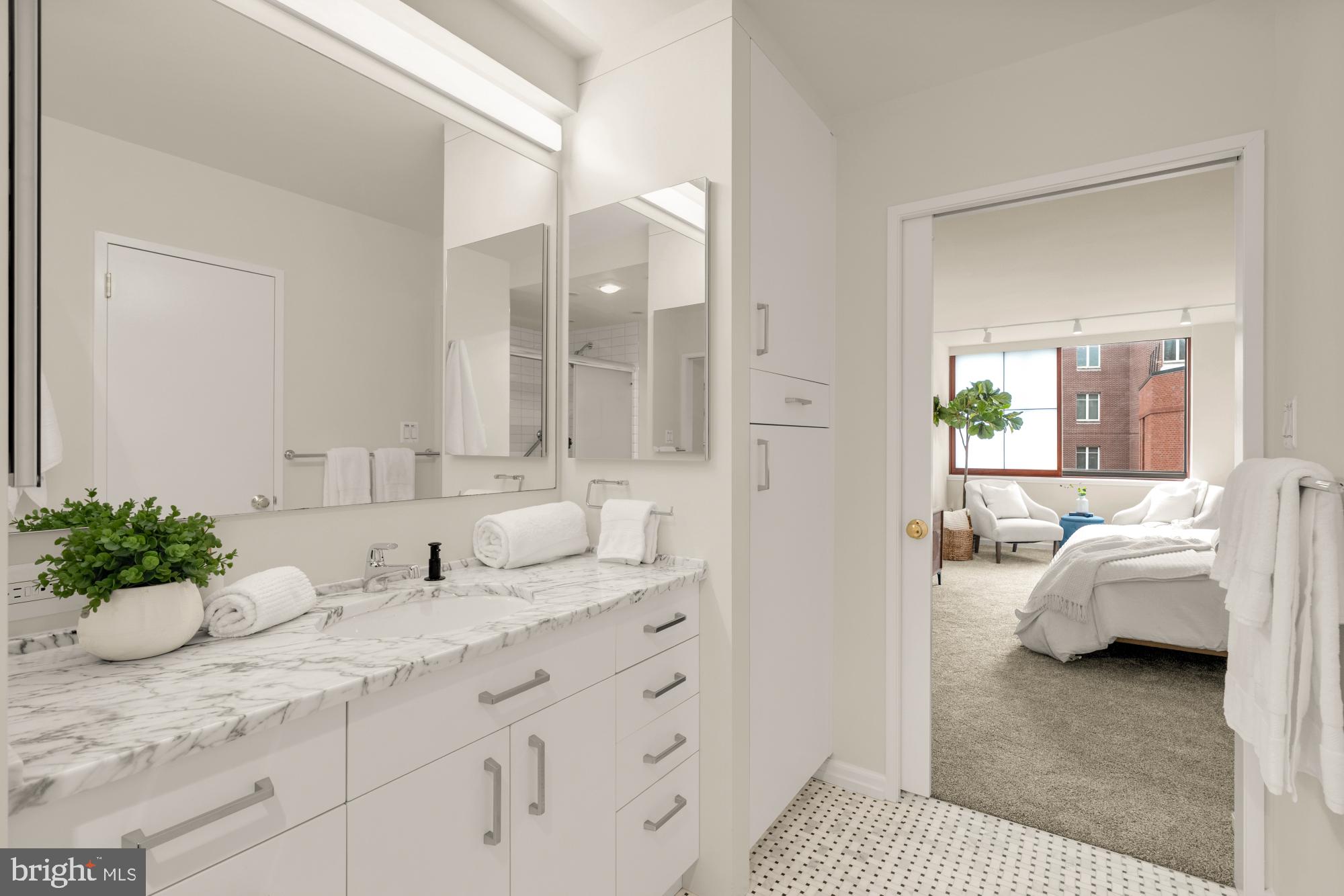 2555 Pennsylvania Avenue Northwest, Unit 617 & 618 Washington, DC 20037 - Photo 38 of 56 a en suite bathroom with a granite countertop sink and a mirror