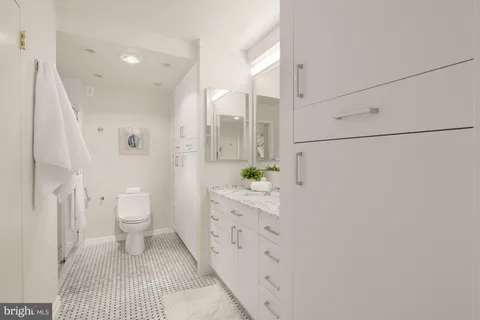 a living room with furniture a mirror and a table