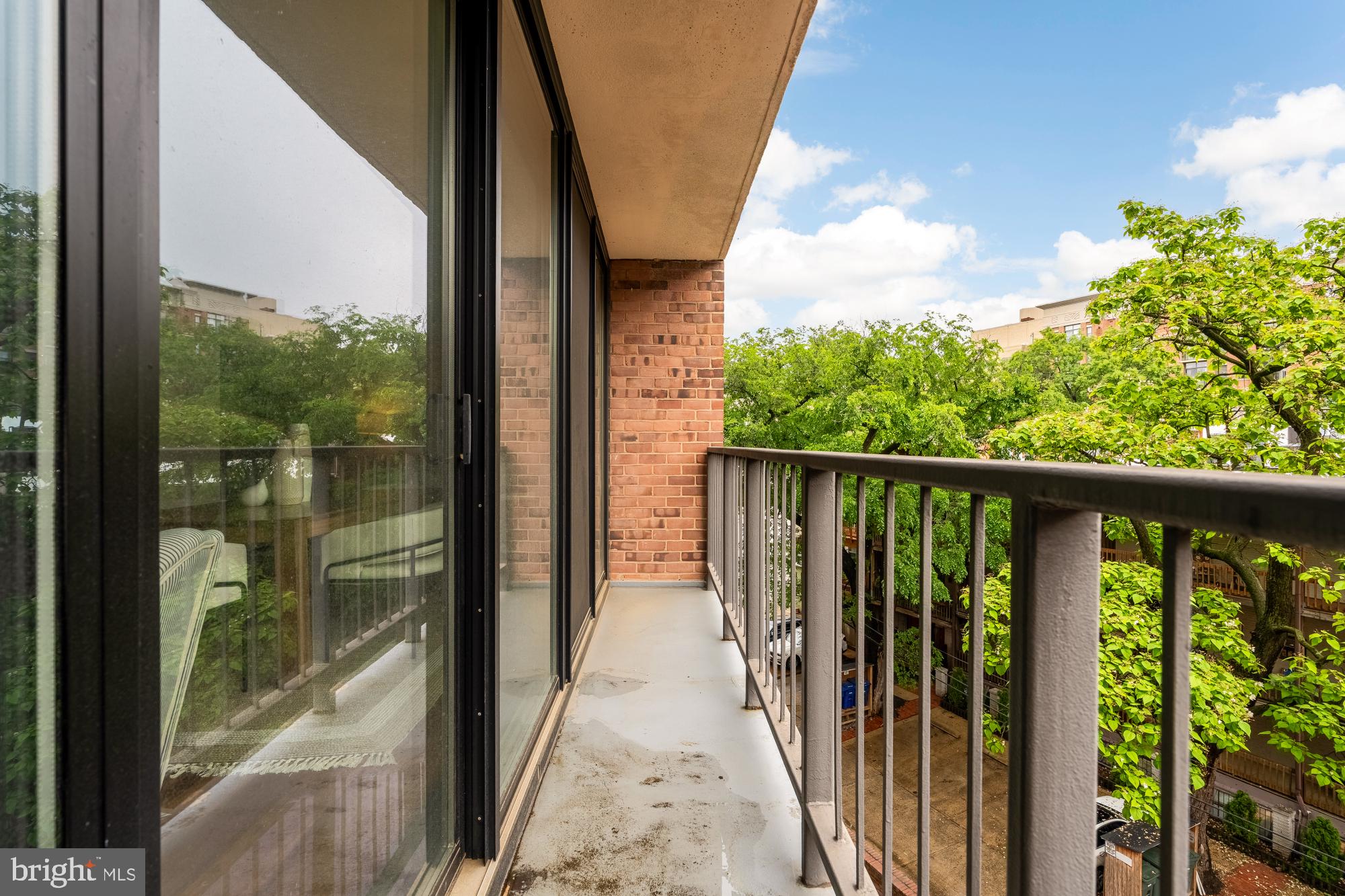 2555 Pennsylvania Avenue Northwest, Unit 617 & 618 Washington, DC 20037 - Photo 47 of 56 a view of a balcony with floor to ceiling windows with wooden floor
