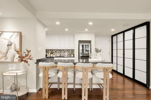 a kitchen with granite countertop kitchen island stainless steel appliances a stove a sink and a refrigerator