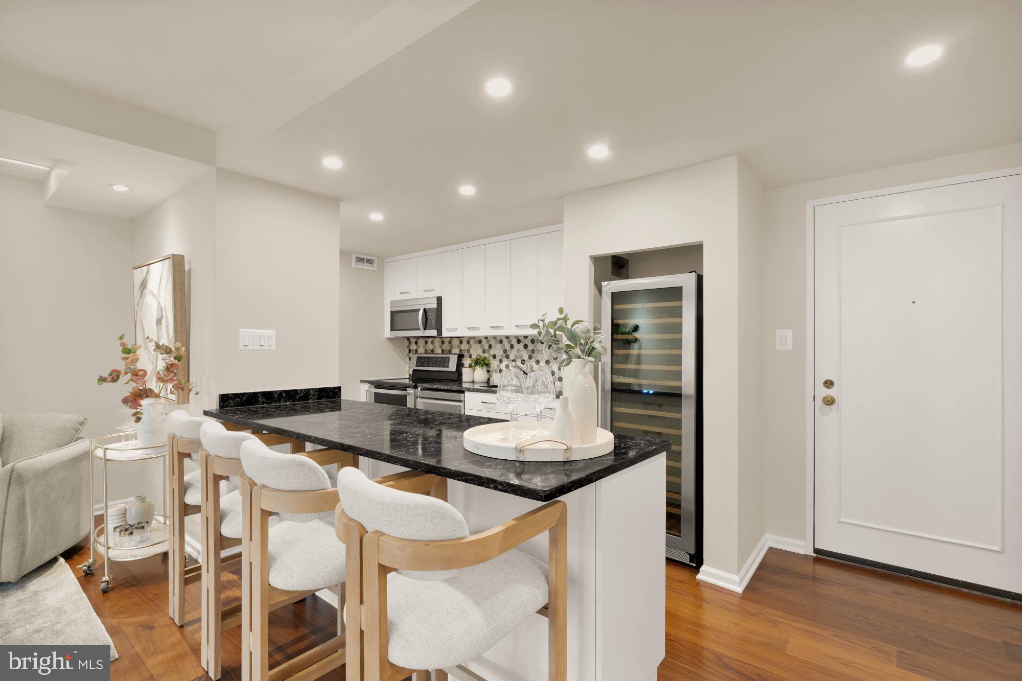 2555 Pennsylvania Avenue Northwest, Unit 617 & 618 Washington, DC 20037 - Photo 9 of 56 a kitchen with granite countertop kitchen island stainless steel appliances a stove a sink and a refrigerator