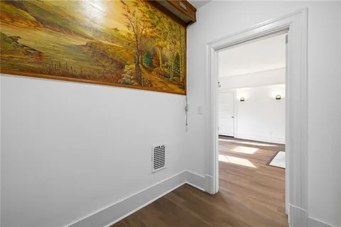 a bathroom with a double vanity sink a toilet a mirror and shower