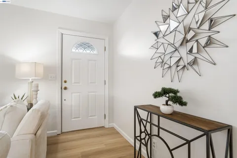 a view of a room with a table chair and wooden floor