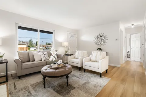a living room with furniture a rug and a table