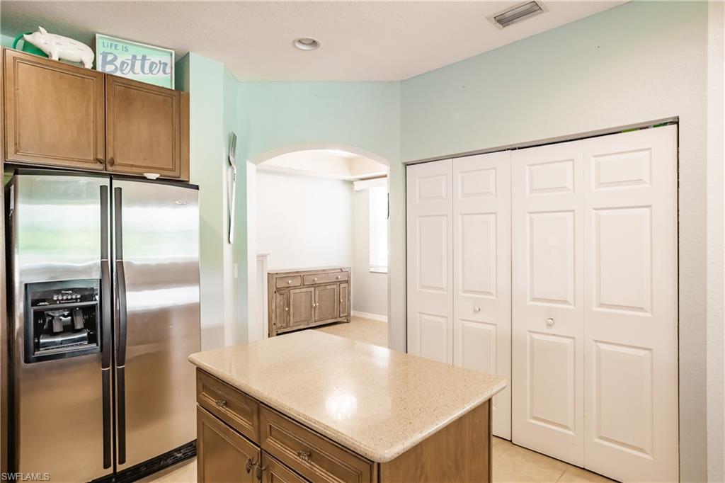 2104 Par Drive Naples, FL 34120 - Photo 11 of 26 a kitchen with stainless steel appliances a refrigerator and a stove