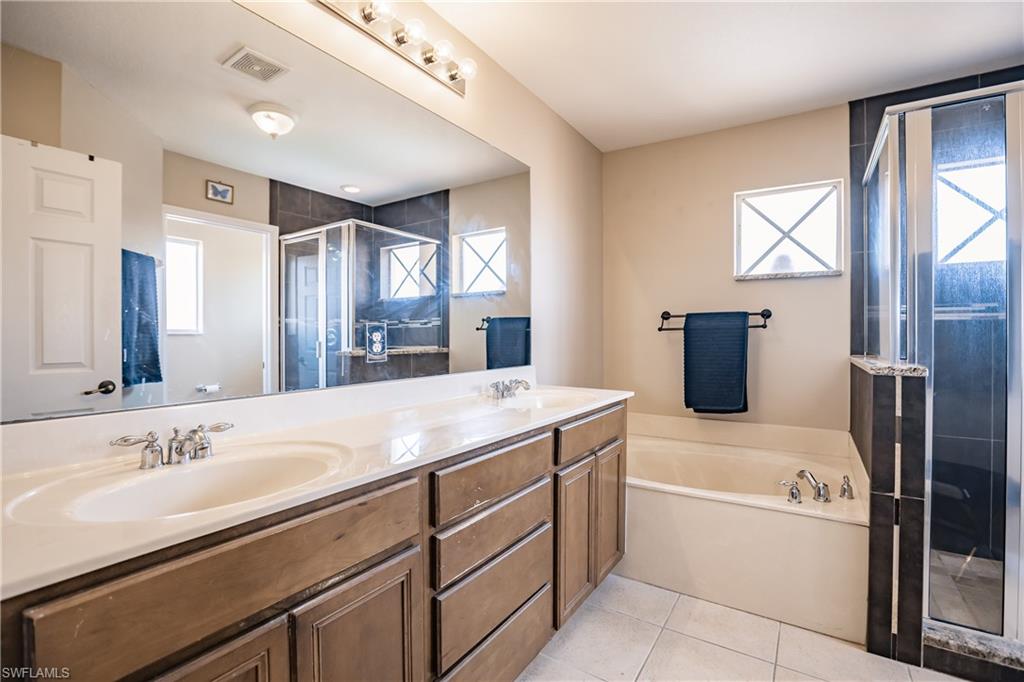 2104 Par Drive Naples, FL 34120 - Photo 19 of 26 a spacious bathroom with a tub sink and mirror