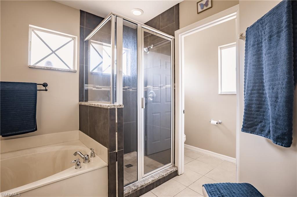 2104 Par Drive Naples, FL 34120 - Photo 20 of 26 a bathroom with a bathtub and a shower